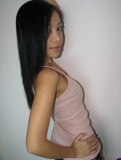 Skinny Asian girl reveals her teensy titties and petite ass on her knees 45235980