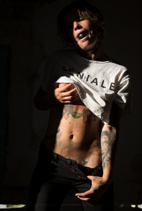 Tattooed female Stacy Cloud wears a ball gag while getting naked at night 63310414