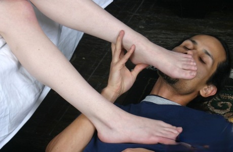 Adorable schoolgirl Mischa has her feet worshiped by older man on her bed