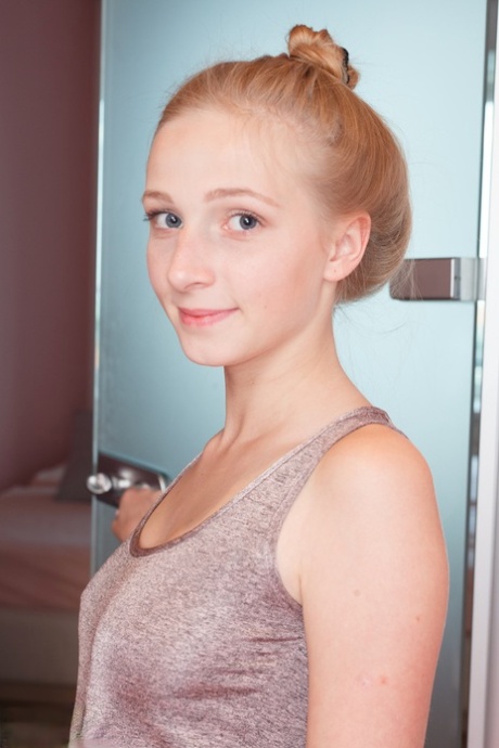 Fair skinned teen wears her hair up while getting wet during a shower 74543752