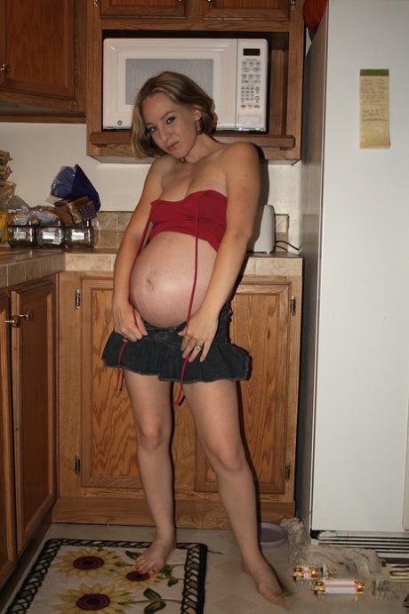 Pregnant amateur Kristi bares her butt before toying her twat in the kitchen 36487091