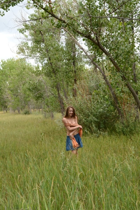 Nice teen Jamie models naked amid long grasses in a country setting 20802574