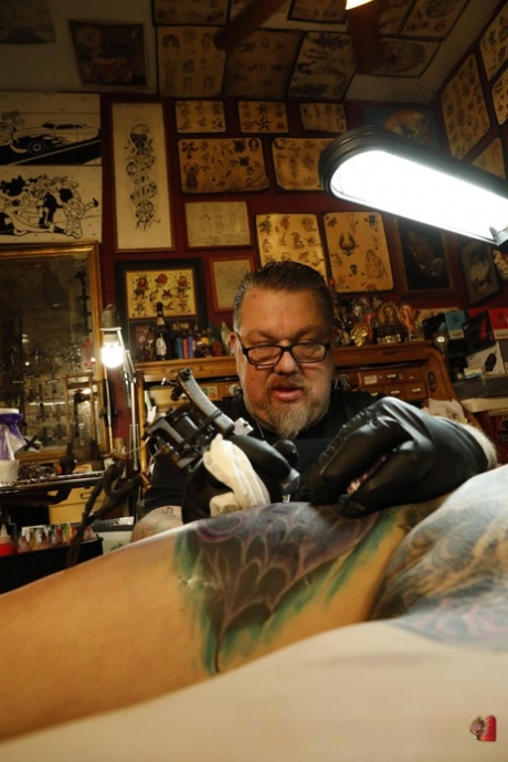 Naked brunette Marie Bossette lies on her back while getting a new tattoo 37913602