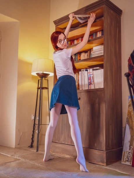 Young redhead Sherice keeps her glasses on while getting naked to masturbate 93469884