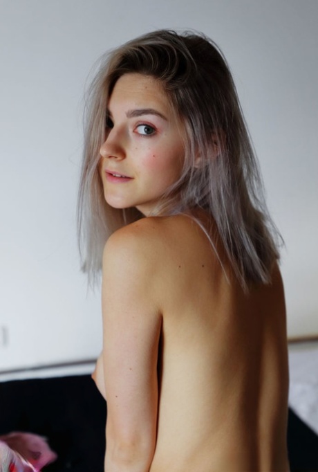 Platinum blonde teen Eva Elfie fingers her horny pussy atop her bed 29127103