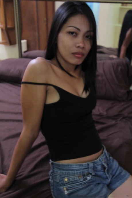 Filipina prostitute Analyn strips naked on a motel bed for a sex tourist 65824185